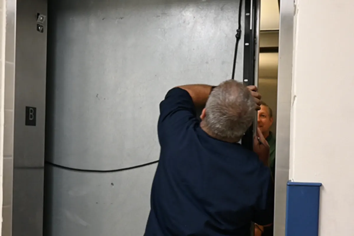Grounds Maintenance company members trapped in the elevator